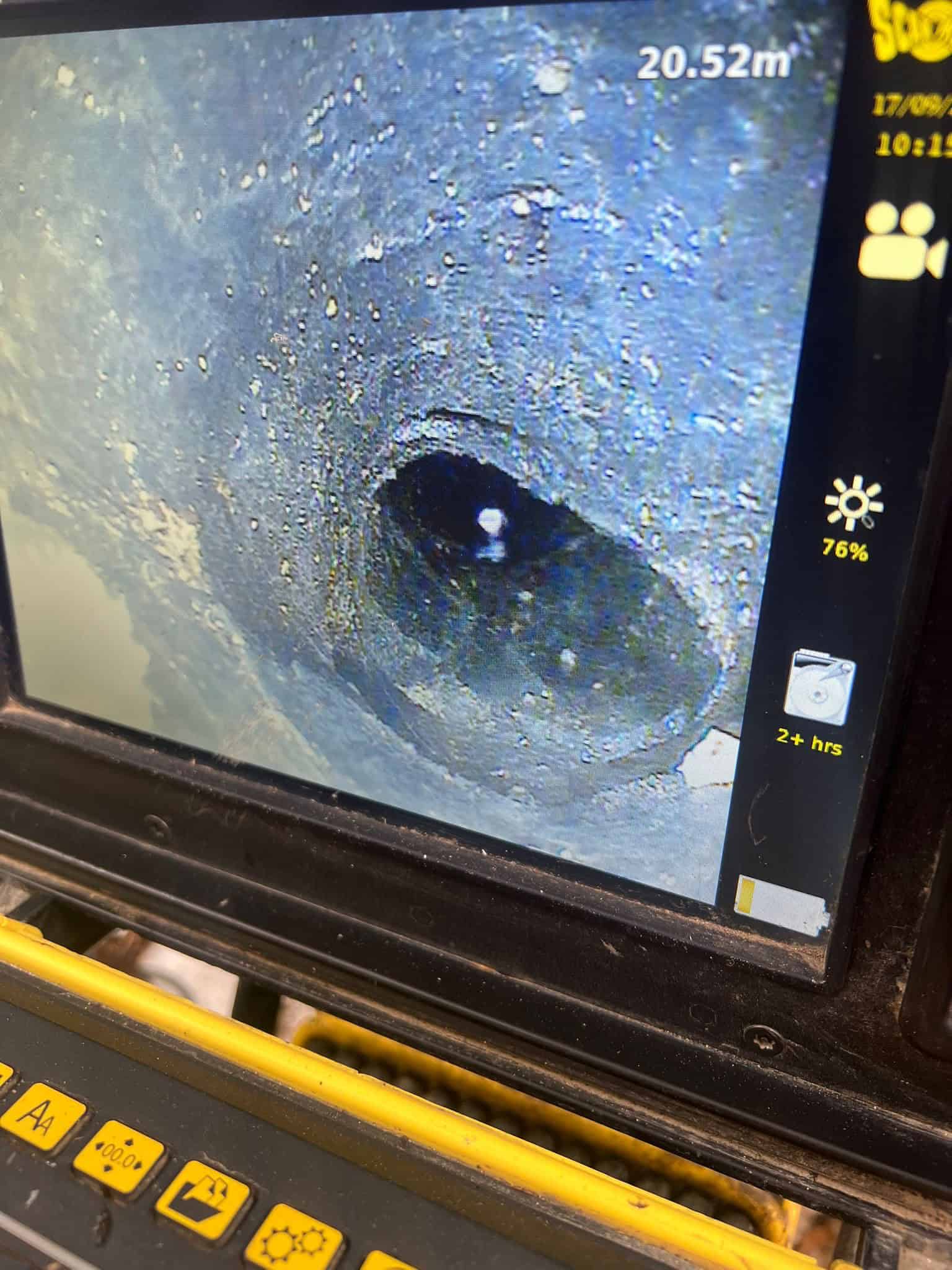 Close-up of pitch fibre drain pipe repair with camera inspection.