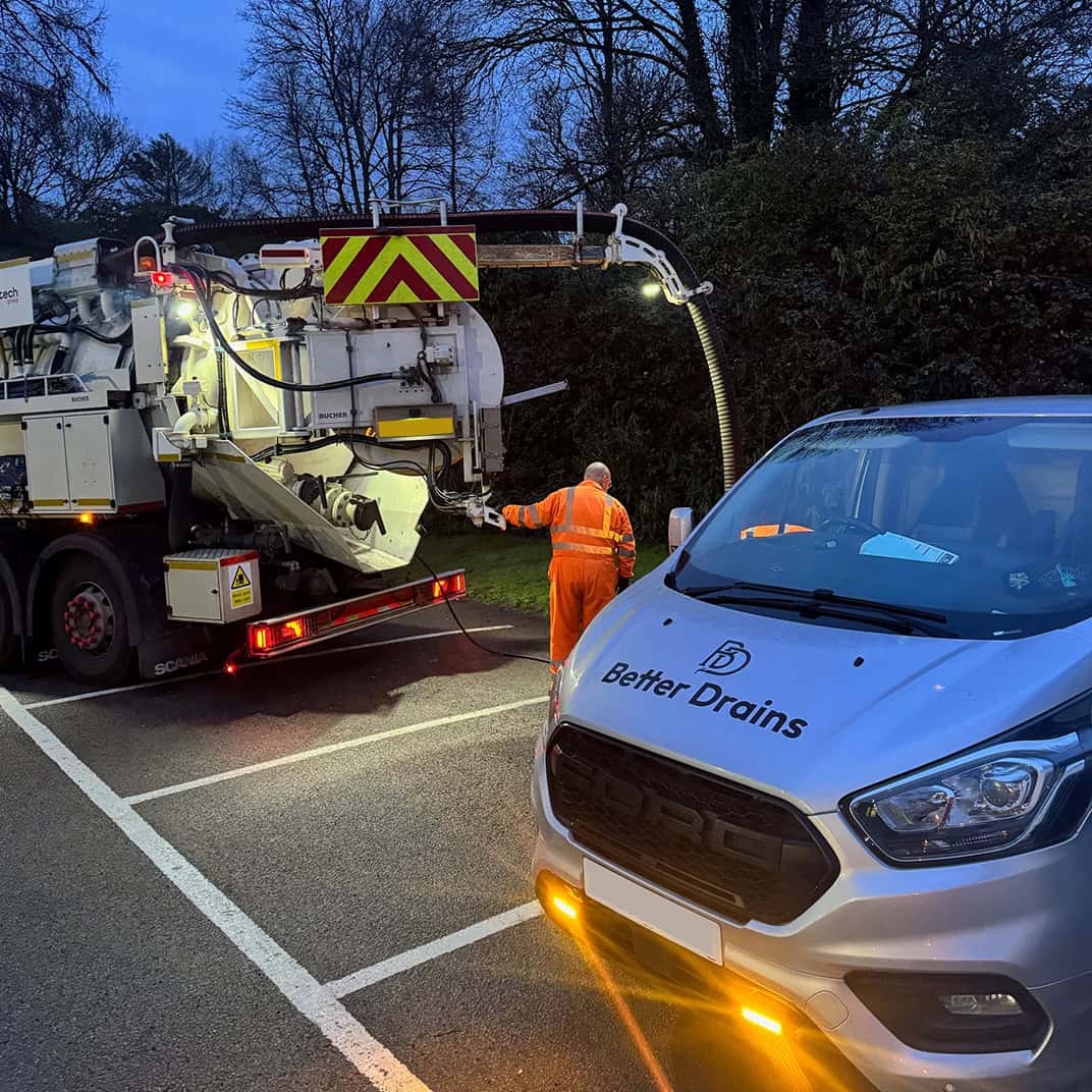 Drainage maintenance vehicle working on road drainage system repair.